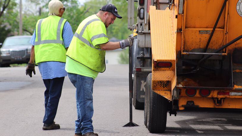 City of Dayton public workers fill a pothole near EastView Avenue in Dayton. JARED THRUSH/STAFF WRITER