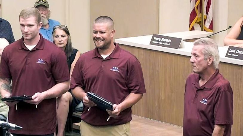 West Carrollton Service Department employee Nick Kolb, Supervisor Todd Pemberton and Service Department employee Billy Branham accept West Carrollton Police Department’s new Patrick M. McCoy award at West Carrollton City Council meeting Tuesday, July 12, 2022. (Not pictured is former Service Department employee Matt Gustin.) The award is to be given to a city of West Carrollton employee “for a specific act, series of acts or conduct that is considered to be outstanding." CONTRIBUTED