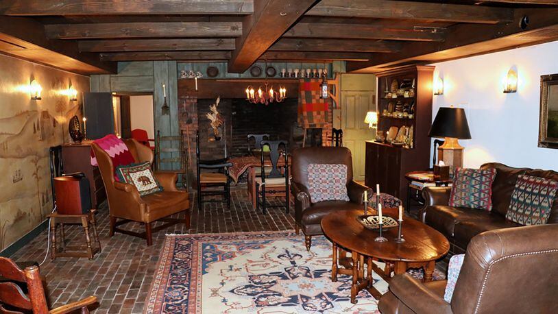 Wood-paneled beamed ceilings add warmth to the lower-level billiard room and a large theater room embellished with an artist’s period-style mural.