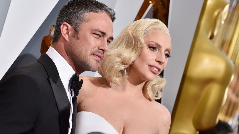 HOLLYWOOD, CA - FEBRUARY 28: Recording artist Lady Gaga (R) and actor Taylor Kinney attend the 88th Annual Academy Awards at Hollywood & Highland Center on February 28, 2016 in Hollywood, California. (Photo by Kevork Djansezian/Getty Images)