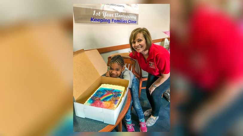 Kelly Brown, of Kettering, deliver a birthday cake to then 7-year-old Shelayah in 2020. Brown founded Kiwanis Club of Dayton's Cakes for Kids program after reading a Dayton Daily News article about a nurse who took a slice of her own son's cake to bring joy to an 8-year-old boy who didn't have one of his own. CONTRIBUTED