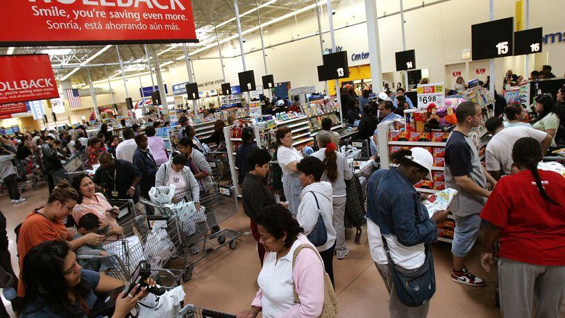 FILE: Shoppers wait in  the checkout line at the Wal-Mart store in Chicago, Illinois. Shoppers across the country will be lining up Wednesday to return gifts they recevied for Christmas. Most stores have a generous return policy, as long as you have a receipt. (Photo by Tim Boyle/Getty Images)