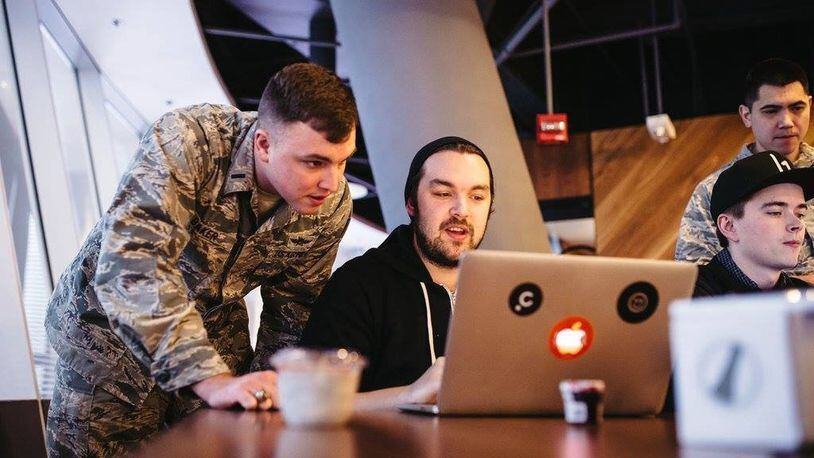 First Lt. Stephen Baker, 352nd Cyber Operations Squadron, watches as one of the Hack the Air Force 2.0 participants attempts to breach the security on a military website Dec. 9, 2017. HtAF2.0 is a Defense Digital Service sponsored event where civilian cyber security experts were invited to identify and report vulnerabilities in more than 300 Air Force sites. (Courtesy photo by HackerOne)