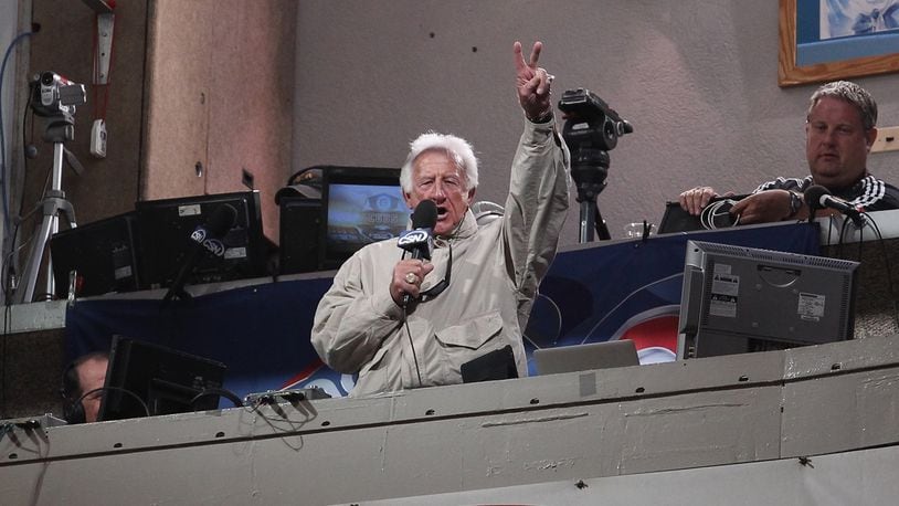 Bob Uecker, broadcaster for the Milwaukee Brewers, sings 'Take Me Out to the Ballgame' during the 7th inning stretch of a game between the Brewers and the Chicago Cubs at Wrigley Field on June 14, 2011 in Chicago, Illinois. The Cubs defeated the Brewers 5-4 in 10 innings.