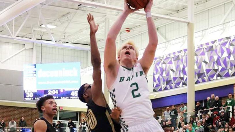 Badin’s Justin Pappas gets up a shot against Thurgood Marshall’s Anthony McComb (10) during Saturday night’s Division II district semifinal basketball game at Middletown’s Wade E. Miller Arena. Marshall won 67-53. CONTRIBUTED PHOTO BY TERRI ADAMS
