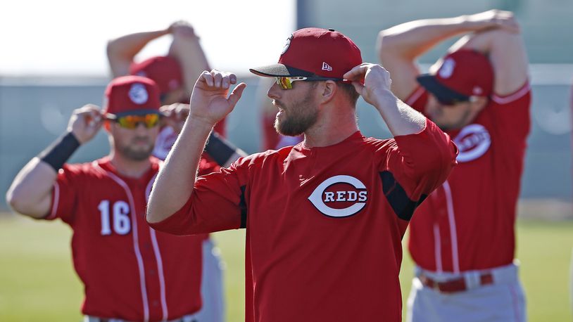 Cincinnati Reds’ Tucker Barnhart (16), Zack Cozart, middle, and Adam Duvall, right, all stretch out at the team’s baseball spring training facility Monday, Feb. 20, 2017, in Goodyear, Ariz. (AP Photo/Ross D. Franklin)