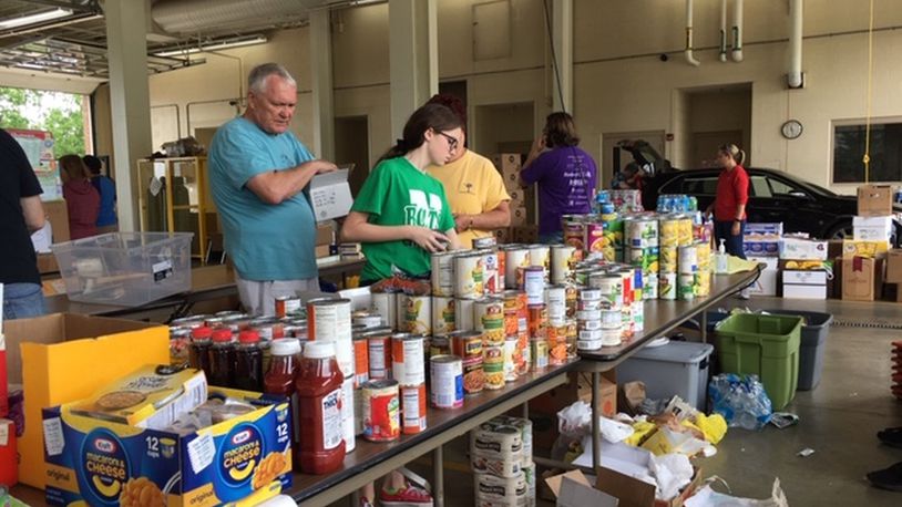Volunteers Saturday accepted donations of food and goods, and then distributed those donations to those in need, at Harrison Twp. Fire Station 94, 2400 Turner Road. That relief effort will continue Sunday from noon until 6 pm. THOMAS GNAU/STAFF