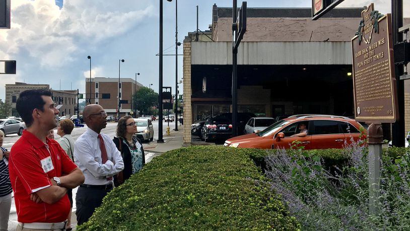 OSU president Michael Drake and other Ohio State Roads Scholars look at a historical marker for Isaac Wise Plum Street Temple in downtown Cincinnati.