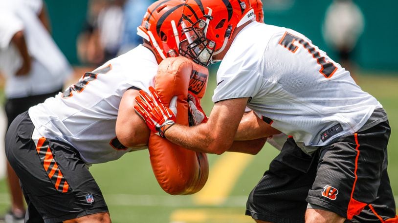 Cincinnati Bengals offensive tackle Andrew Whitworth, right, and guard Alex Cooper make contact during a drill on the first day of mandatory mini camp Tuesday, June 14 at Paul Brown Stadium in Cincinnati. NICK GRAHAM/STAFF