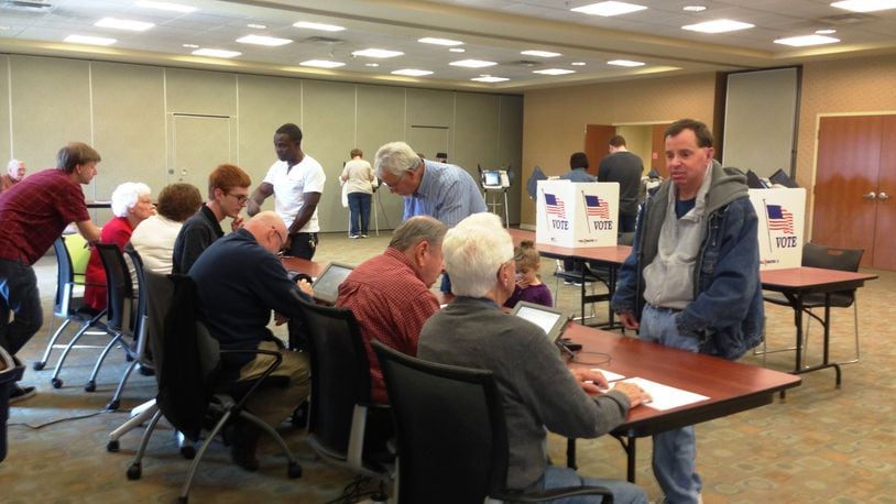 Voters and polling workers at the Butler County Board of Elections, Tuesday, Nov. 4, 2014. CHELSEY LEVINGSTON / STAFF