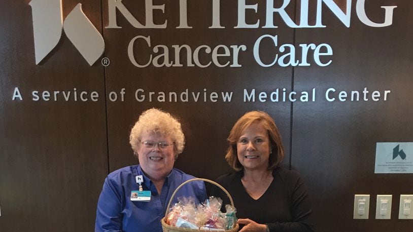 When two of her closest friends were battling cancer eight years ago, Washington Township resident, Sue Forrest, decided to provide comfort to them by knitting Comfee Caps for them to wear. Forrest, left, presented some caps to patients at theKettering Health Network Cancer Center.