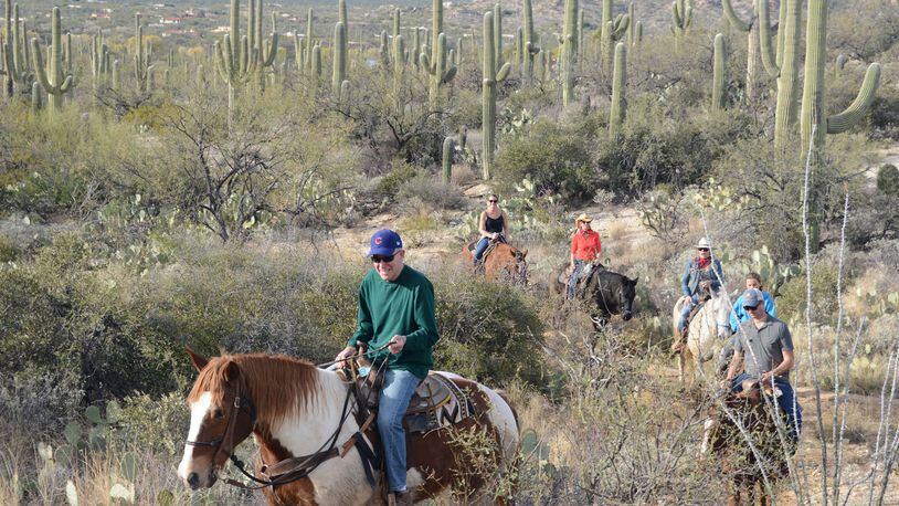 The writer’s dad, George Fink, leads the pack on a family trail ride through the desert. (Bill Fink/Chicago Tribune/TNS)