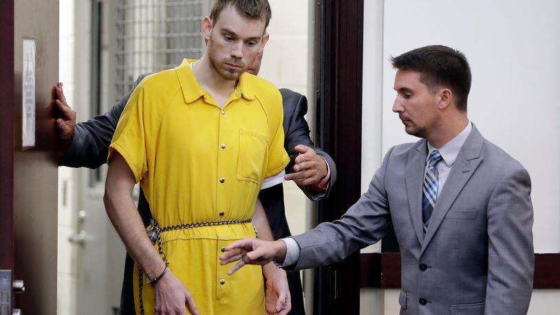 Travis Reinking, left, enters a courtroom for a hearing Wednesday, Aug. 22, 2018, in Nashville, Tenn. Reinking is charged with killing four people during a shooting at a Waffle House restaurant in Nashville in April.