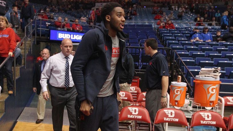Josh Cunningham walks on crutches to the bench at UD Arena earlier this month. David Jablonski/Staff