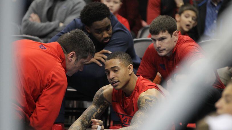 Trainers attend to Kyle Davis in the second half at Duquesne on Jan. 14, 2017.