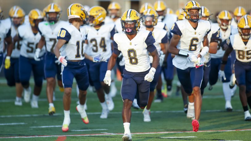 Springfield's Jaivian Norman (8) leads the team onto the field before a game against Beavercreek Friday, Sept. 16, 2022. Michael Cooper/CONTRIBUTED