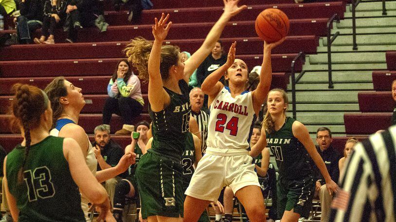 Carroll’s Allie Stefanek shoots over Hamilton Badin’s Maddie Thompson on Monday night at Lebanon High School . Carroll defeated Badin 40-22 to advance to Friday’s Division II district final at Mason. Jeff Gilbert/CONTRIBUTED