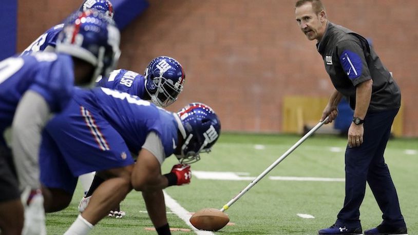 New York Giants defensive coordinator Steve Spagnuolo, right, runs a drill with his players during the team's organized team activities at its NFL football training facility, Thursday, May 25, 2017, in East Rutherford, N.J. (AP Photo/Julio Cortez)