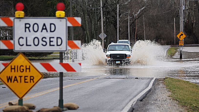 A truck drives through the high water on Lower Valley Pike Sunday. Bill Lackey/Staff