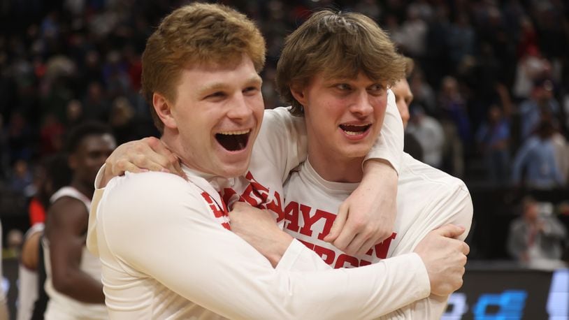 Dayton's Will Maxwell and Atticus Schuler celebrate a victory against Nevada in the first round of the NCAA tournament on Thursday, March 21, 2024, at the Delta Center in Salt Lake City, Utah. David Jablonski/Staff