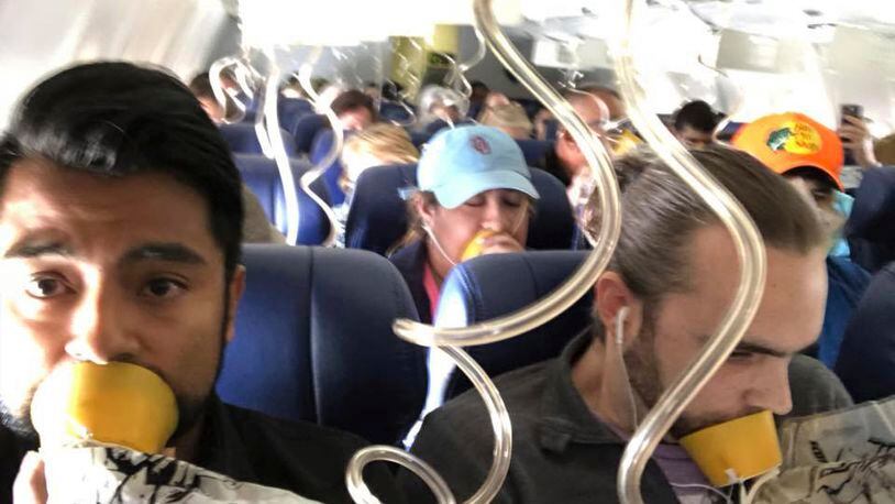In this April 17, 2018 photo provided by Marty Martinez, Martinez, left, appears with other passengers after a jet engine blew out on the Southwest Airlines Boeing 737 plane he was flying in from New York to Dallas, resulting in the death of a woman who was nearly sucked from a window during the flight with 149 people aboard. A preliminary examination of the blown jet engine that set off a terrifying chain of events showed evidence of “metal fatigue,” according to the National Transportation Safety Board. (Marty Martinez via AP)