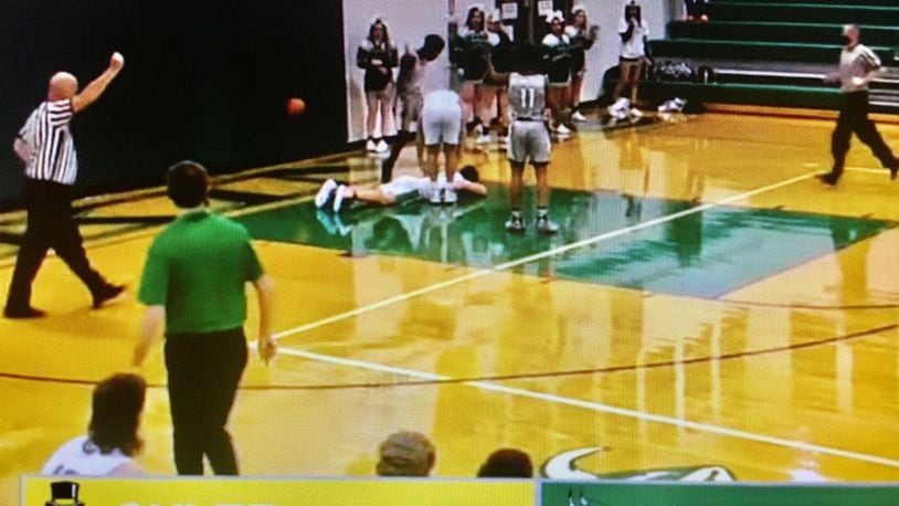 A screen shot photo from a game video posted online by Butler County Sports Report shows an Cincinnati Oyler High School player standing over a New Miami High School player he just fouled. Officials from both schools continued to investigate the Oyler player's alleged kicking of the prone New Miami player in the head. (Butler County Sports Report image)