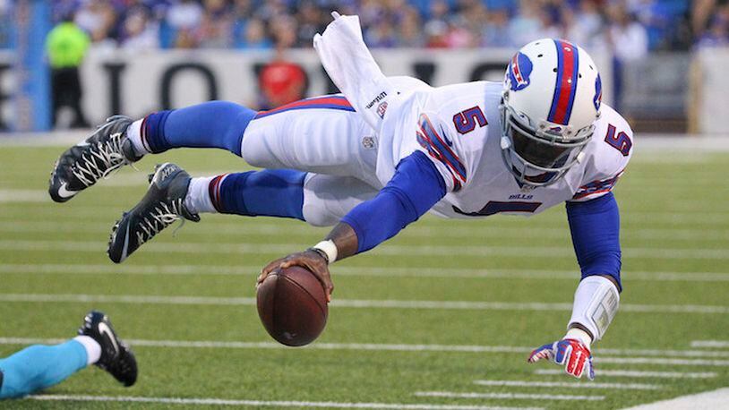 FILE - In this Aug. 15, 2015 file photo, Buffalo Bills quarterback Tyrod Taylor (5) dives for the first down marker during the first half of an NFL preseason football game against the Carolina Panthers in Orchard Park, N.Y. Two people familiar with the trade said Friday, March 9, 2018, the Cleveland Browns have agreed to acquire Taylor from the Bills for a third-round draft pick this year.  (AP Photo/Bill Wippert, File)