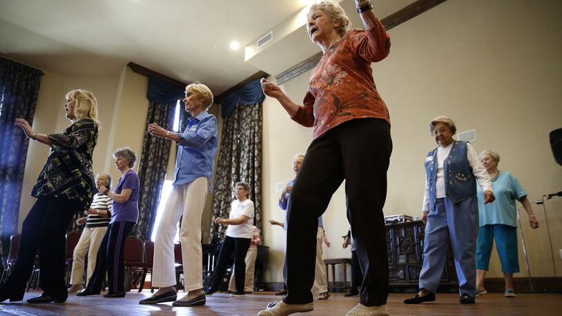 Sarah Winlock (in orange) dances during a line dancing class for seniors at Atria Canyon Creek in Plano, Texas on April 16, 2018. (Nathan Hunsinger/Dallas Morning News/TNS)