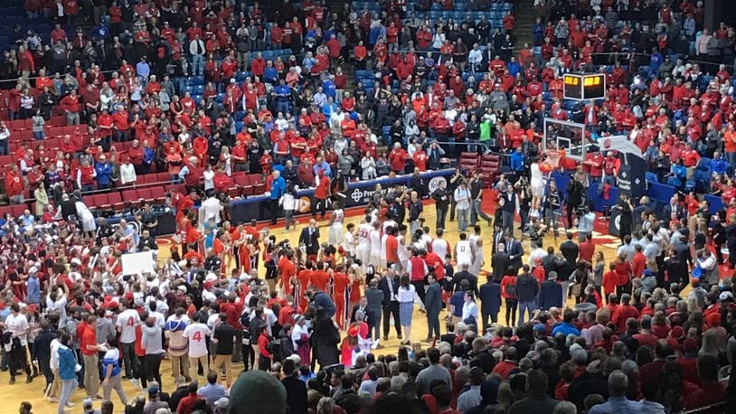Dayton celebrates an A-10 title after beating Virginia Commonwealth on March 1, 2017, at UD Arena. Contributed photo