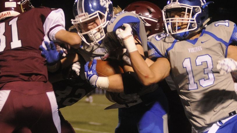 Miamisburg senior RB Jake Neatherton (with ball) is assisted by teammate Tyler Johnson. Lebanon hosted Miamisburg in a GWOC National West high school football game on Friday, Oct. 14, 2016. MARC PENDLETON / STAFF