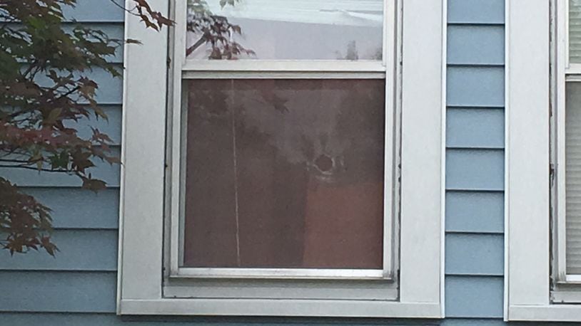 There’s a hole in a front window of the home on Morse Avenue where Mackenna Kronenberger died early Wednesday morning. MIKE CAMPBELL/STAFF
