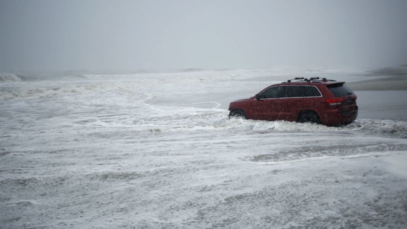 A Jeep Grand Cherokee sits stranded on a beach during Hurricane Dorian in Myrtle Beach, South Carolina, on Thursday.