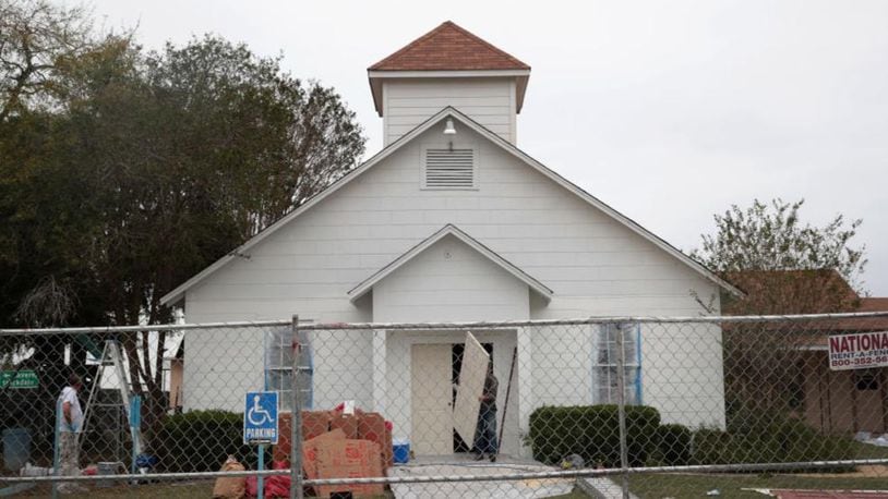 SUTHERLAND SPRINGS, TX - NOVEMBER 09:  Workers replace the bullet-scarred front door of the First Baptist Church of Sutherland Springs on November 9, 2017 in Sutherland Springs, Texas. The door was being replaced with a new one after a gunman, Devin Patrick Kelley, shot and killed the 26 people and wounded 20 others when he opened fire during a Sunday service at the church on November 5th.  (Photo by Scott Olson/Getty Images)