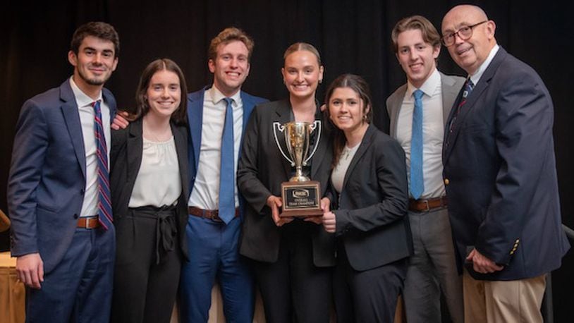 The UD sales team poses with their first-place trophy. Photo from left: Junior John Sommers, Senior Clare Gaffney, Senior Will Blubaugh, Junior Alexa Plummer, Senior Gabby Rullo, Junior Hans Rottmann, and Faculty Sales Coach Tony Krystofik. Courtesy of University of Dayton.