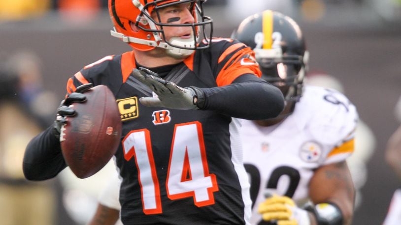 Bengals quarterback Andy Dalton (14) looks to complete a pass during their game against the Steelers at Paul Brown Stadium, Sunday, Dec. 18, 2016. GREG LYNCH / STAFF