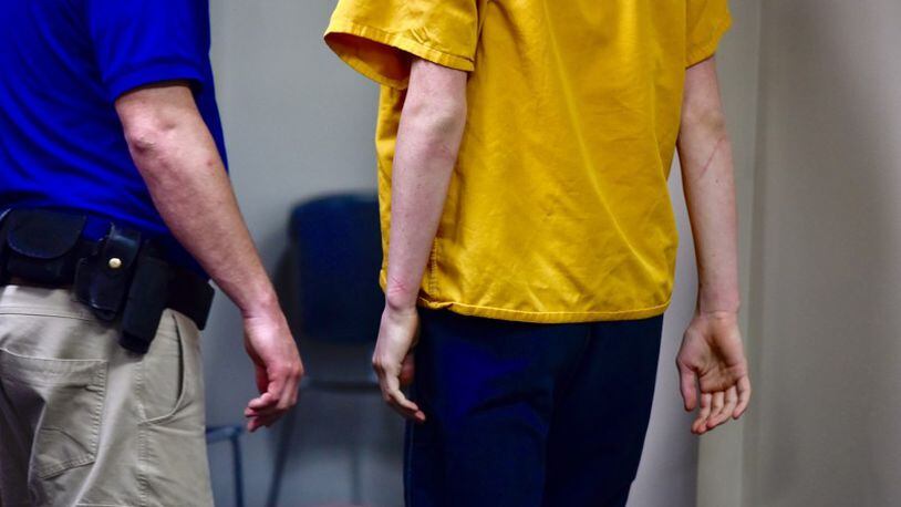 A 16-year-old boy charged with aggravated murder and other felonious for the shooting death of a Loveland man in a drug deal gone bad will remain behind bars until next month when his next court appearance is scheduled in juvenile court. NICK GRAHAM/STAFF