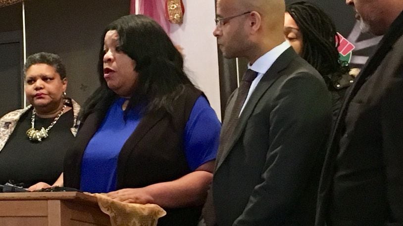 Sabrina Jordan (second from left), the mother of Jamarco McShann, speaks during Wednesday’s press conference about the wrongful death lawsuit filed in Dayton’s U.S. District Court. McShann was shot and killed last year by Moraine police, who said McShann did not respond to messages to drop a weapon. McShann had been asleep in his car. To Jordan’s left is her attorney, Andrew Stroth. STAFF/MARK GOKAVI