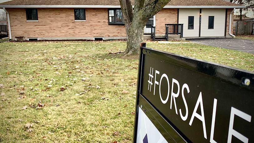 A home for sale on Bellefontaine Road in Huber Heights Wednesday, Nov. 22, 2023. The amount of homes sold each month continues to trend down through October compared to year-to-date numbers through October 2022, while the average home sale price continues to rise. MARSHALL GORBY/STAFF