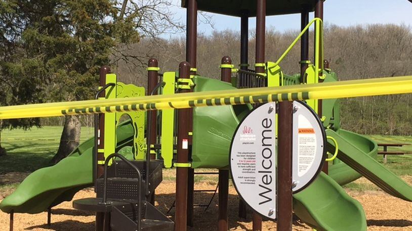 Caution tape was put up around playground equipment at Layer Park in Miami Twp., where work continues to be done after the U.S. Environmental Protection Agency removed about 60 tons of soil due to lead contamination that closed the park in early 2016. NICK BLIZZARD/STAFF