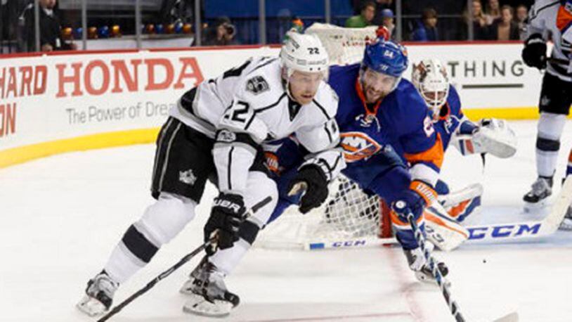 Los Angeles Kings center Trevor Lewis (22) controls the puck against New York Islanders right wing Stephen Gionta (24) during the first period of an NHL hockey game, Saturday, Jan. 21, 2017, in New York. (AP Photo/Julie Jacobson)