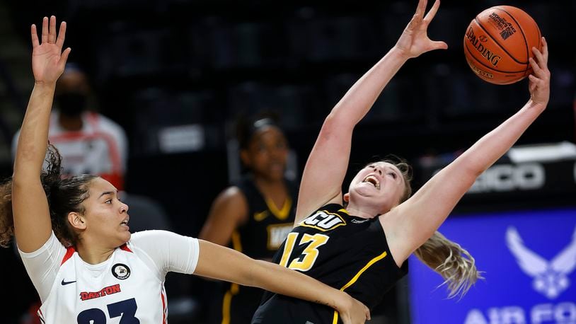 VCU's Chloe Bloom, right, reaches for rebound against Dayton's Mariah Perez during an NCAA college basketball game in the semifinal round of the Atlantic 10 conference tournament Saturday, March 13, 2021, in Richmond, Va. (Alexa Welch Edlund/Richmond Times-Dispatch via AP)