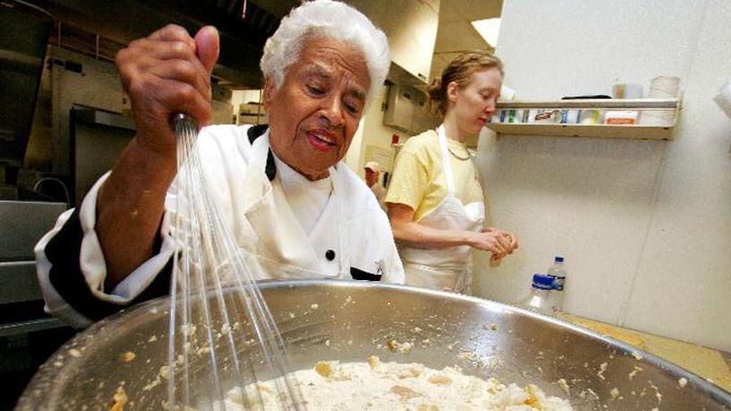 In this April 12, 2006, file photo, Leah Chase mixes her bread pudding at Muriel's restaurant in New Orleans.