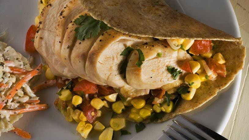 Corn and tomatoes make up a summery salsa for a grilled chicken wrap, an easy dinner for lazy days. (Bob Fila/Chicago Tribune/TNS)