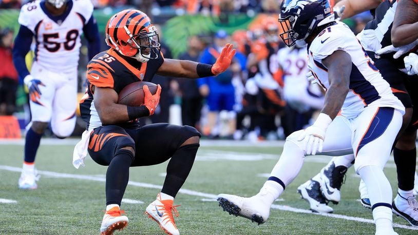 CINCINNATI, OH - DECEMBER 2: Giovani Bernard #25 of the Cincinnati Bengals attempts to run the ball past Todd Davis #51 of the Denver Broncos during the third quarter at Paul Brown Stadium on December 2, 2018 in Cincinnati, Ohio. (Photo by Andy Lyons/Getty Images)