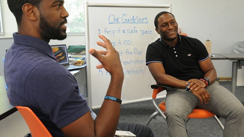 Ralph Davis Jr. (left) and Kelley Howard Jr. talk about their YWCA summer camp in Huber Heights that teaches boys how to be men. MARSHALL GORBY\STAFF