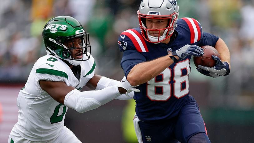 New England Patriots tight end Mike Gesicki (88) carries the ball against New York Jets safety Adrian Amos (0) during the first quarter of an NFL football game, Sunday, Sept. 24, 2023, in East Rutherford, N.J. (AP Photo/Adam Hunger)
