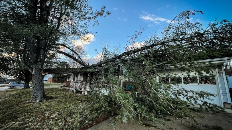 Part of a tree fell on a house on Kutcher Street in Miamisburg on Thursday, Jan. 19, 2023. JIM NOELER/STAFF