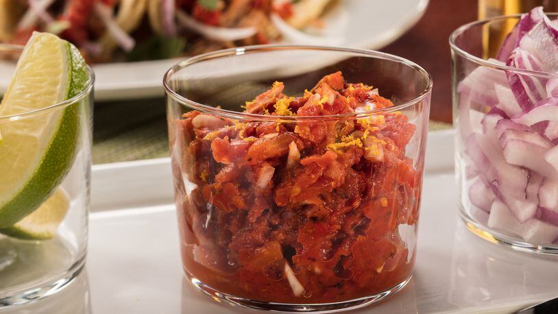 Canned fire-roasted tomatoes provide a quick base for a salsa that picks up the chipotle and orange flavors used for cooking the pork. Food styling by Mark Graham. (Zbigniew Bzdak/Chicago Tribune/TNS)