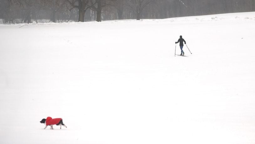 FILE PHOTO: People and their dogs enjoy and afternoon in the sleet and snow.