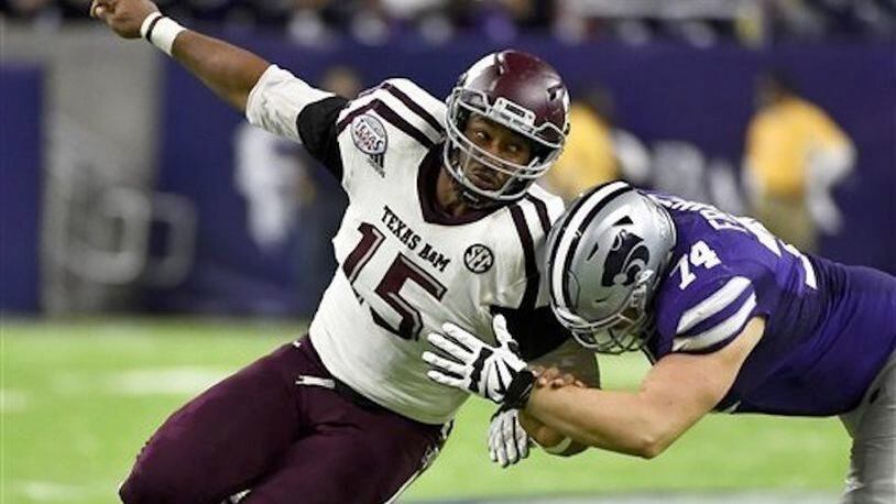 In this Dec. 28, 2016, file photo, Texas A&M's Myles Garrett (15) tries to get around Kansas State offensive lineman Scott Frantz during the second half of the Texas Bowl NCAA college football game in Houston. Elite speed, quickness and strength add up to a potentially dominant pass rusher with only the need to stay on the field more. Odds-on favorite to be No. 1 overall pick. (AP Photo/Eric Christian Smith, File)
